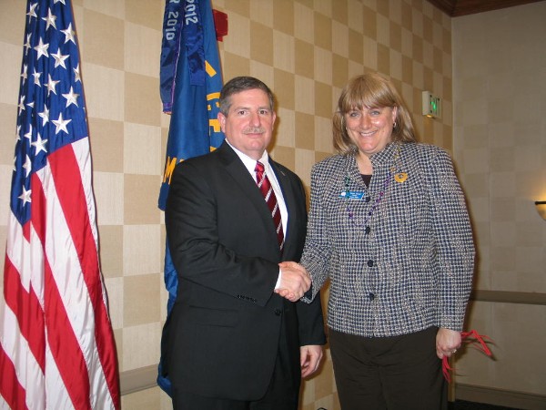 Teresa Duvall, chapter president, extends gratitude to Dr. Thomas P. Russell, director, Air Force Office of Scientific Research, who spoke at the February luncheon.